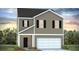 Two-story home with tan siding, black shutters, white trim, and an attached two-car garage at 257 Watersglen Dr, Summerville, SC 29486