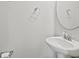 A charming half bathroom features a pedestal sink, a round mirror, and chrome fixtures at 258 Godwit Dr, Summerville, SC 29486