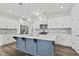 Modern kitchen with white cabinets, quartz countertops, and a stylish blue island at 258 Godwit Dr, Summerville, SC 29486