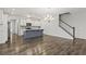Open-concept living space with wood floors and staircase view and modern chandelier at 258 Godwit Dr, Summerville, SC 29486