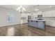 Bright, open-concept living space with wood floors and modern lighting and kitchen at 258 Godwit Dr, Summerville, SC 29486