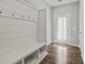 Mudroom area with a bench, storage cubbies, and hooks, adjacent to an outside door at 258 Godwit Dr, Summerville, SC 29486