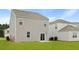 Backyard view, revealing the home's exterior, siding, and windows, with a glimpse of the adjacent properties at 287 Watersglen Dr, Summerville, SC 29486