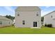 A close-up of the rear of the house, highlighting the backyard space and a sliding glass door entrance at 287 Watersglen Dr, Summerville, SC 29486