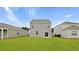 A view of the backyard featuring a well-maintained lawn and the rear of the home, showcasing the exterior siding at 287 Watersglen Dr, Summerville, SC 29486