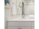 Bathroom featuring white cabinets, a white countertop, and a decorative mirror and artwork at 329 Pine Crest View Dr, Summerville, SC 29486