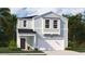 Charming two-story home featuring a light blue exterior, a covered porch, and an attached two-car garage at 329 Pine Crest View Dr, Summerville, SC 29486