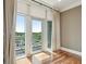 Bright room with hardwood floors and balcony access featuring views of the neighborhood at 341 Cooper River Dr, Mount Pleasant, SC 29464