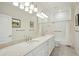 Bright bathroom showcasing a double vanity, large mirror, and tiled walls and floors at 341 Cooper River Dr, Mount Pleasant, SC 29464