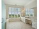 Bathroom features tiled floors, dual sinks, vanity, large window, soaking tub, and shower at 341 Cooper River Dr, Mount Pleasant, SC 29464