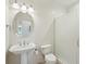 Bright bathroom featuring a pedestal sink, round mirror, tiled walls, and glass shower at 341 Cooper River Dr, Mount Pleasant, SC 29464