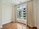 Bright bedroom featuring hardwood floors, neutral walls, and a large window with curtains at 341 Cooper River Dr, Mount Pleasant, SC 29464