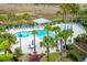 Community pool area with pool furniture, palm trees, and landscaping at 341 Cooper River Dr, Mount Pleasant, SC 29464