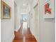 Bright, spacious hallway with gleaming hardwood floors and stylish artwork leading to beautiful ocean view at 341 Cooper River Dr, Mount Pleasant, SC 29464