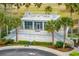 Exterior shot of the Harbor House building, with palms and landscaping at 341 Cooper River Dr, Mount Pleasant, SC 29464