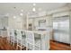 Gourmet kitchen boasts stainless steel appliances, white cabinetry and a large center island with bar stool seating at 341 Cooper River Dr, Mount Pleasant, SC 29464
