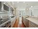 Modern kitchen with stainless steel appliances, white cabinets, and marble countertops with a breakfast bar at 341 Cooper River Dr, Mount Pleasant, SC 29464