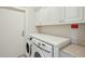 Laundry room featuring a front-load washer/dryer and white countertop with storage cabinets at 341 Cooper River Dr, Mount Pleasant, SC 29464