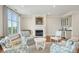 Bright and airy living room features a cozy fireplace, wet bar and comfortable seating near large picture windows at 341 Cooper River Dr, Mount Pleasant, SC 29464