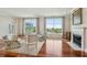 Sunlit living room with hardwood floors, large windows offering picturesque water views, and comfortable seating at 341 Cooper River Dr, Mount Pleasant, SC 29464