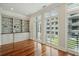 Bright living room features custom built-ins, plantation shutters, and gleaming hardwood floors at 341 Cooper River Dr, Mount Pleasant, SC 29464