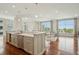 Open concept kitchen and living room area with hardwood floors, large windows, and stainless steel appliances at 341 Cooper River Dr, Mount Pleasant, SC 29464