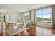 Bright living room featuring hardwood floors, comfortable seating, and large windows showcasing scenic water views at 341 Cooper River Dr, Mount Pleasant, SC 29464