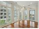Sun-filled living room featuring hardwood floors, plantation shutters, and views of the surrounding neighborhood at 341 Cooper River Dr, Mount Pleasant, SC 29464