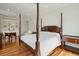 Bright main bedroom features hardwood floors and a four poster bed under a ceiling fan at 341 Cooper River Dr, Mount Pleasant, SC 29464
