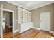 Well-lit office space featuring hardwood floors, white built-in shelving, and doors at 341 Cooper River Dr, Mount Pleasant, SC 29464