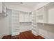 Walk-in closet features hardwood floors and ample built-in white shelving and storage at 341 Cooper River Dr, Mount Pleasant, SC 29464