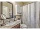 Well-lit bathroom with granite countertops, modern fixtures, and a shower with decorative curtain at 3697 Stamler Ct, Mount Pleasant, SC 29466