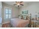 Charming bedroom with a brass bed frame, patterned bedding, hardwood floors, and a ceiling fan at 3697 Stamler Ct, Mount Pleasant, SC 29466