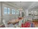 The dining room with hardwood floors, white chairs, a rustic table, and easy kitchen access at 3697 Stamler Ct, Mount Pleasant, SC 29466