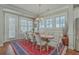 Bright dining room with hardwood floors, a rustic table, white chairs, and ample natural light at 3697 Stamler Ct, Mount Pleasant, SC 29466