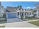 Charming blue two-story home with inviting front porch, attached garage, and well-manicured landscaping at 3697 Stamler Ct, Mount Pleasant, SC 29466