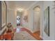 Open foyer with hardwood floors, arched doorways, and stylish decor creating a welcoming entrance at 3697 Stamler Ct, Mount Pleasant, SC 29466