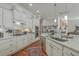 A modern kitchen features stainless steel appliances, white cabinetry, and an island with barstool seating at 3697 Stamler Ct, Mount Pleasant, SC 29466