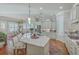 Open kitchen with island, stainless steel appliances, barstool seating, and access to the dining room at 3697 Stamler Ct, Mount Pleasant, SC 29466