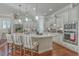 Bright, modern kitchen with white cabinets, large island, stainless steel appliances, and stylish seating at 3697 Stamler Ct, Mount Pleasant, SC 29466