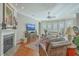 Comfortable living room with a fireplace, neutral walls, hardwood floors, and a ceiling fan at 3697 Stamler Ct, Mount Pleasant, SC 29466