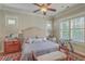 Cozy bedroom features a ceiling fan, neutral walls, and natural light from shuttered windows at 3697 Stamler Ct, Mount Pleasant, SC 29466