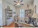 Home office with built-in shelving, a ceiling fan, hardwood floors, and ample natural light at 3697 Stamler Ct, Mount Pleasant, SC 29466