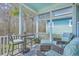 Cozy screened-in porch with comfortable seating and a view of the surrounding trees and foliage at 3697 Stamler Ct, Mount Pleasant, SC 29466