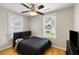 Bedroom with wood floors, black queen bed frame and a ceiling fan at 3728 Tim St, North Charleston, SC 29405