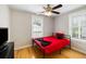 Bedroom with wood floors, a red queen bed frame and a ceiling fan at 3728 Tim St, North Charleston, SC 29405