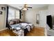 Cozy bedroom featuring a ceiling fan, hardwood floors, and a queen-sized bed with floral bedding at 3728 Tim St, North Charleston, SC 29405