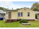 Charming yellow home with brick foundation and small patch of grass at 3728 Tim St, North Charleston, SC 29405