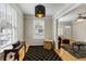 Cozy living room with hardwood floors, a decorative pendant light, and large windows at 3728 Tim St, North Charleston, SC 29405