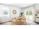 Bright dining space featuring a round wooden table, woven rug, and large windows for a warm, inviting atmosphere at 384 Willows Crescent Dr, Moncks Corner, SC 29461